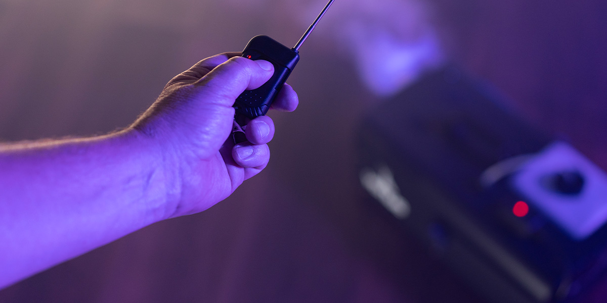 Man Holding Remote Control For Fog Machine